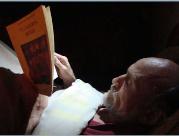  Reading Rumi in bed by solar powered LED light.